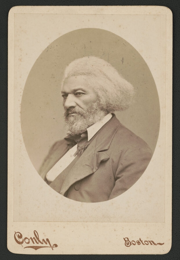 An older African American man gazes into the distance in an oval portrait mounted on cardstock. Text on the cardstock reads "Conly" and "Boston."