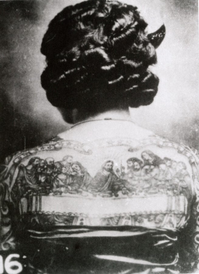 A woman's back is tattooed with a well-done, large reproduction of "The Last Supper" by da Vinci.