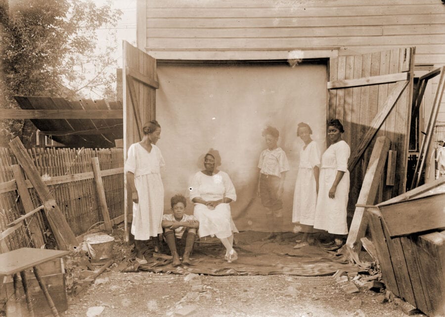 Of the six people shown here, three appear to be ghostly figures. All are African American and wearing white.